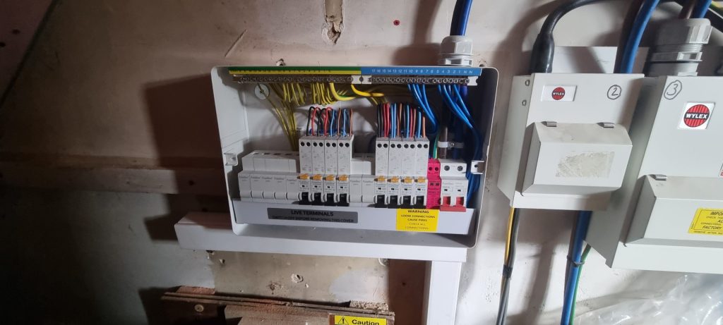 Electrician testing residential fuse board