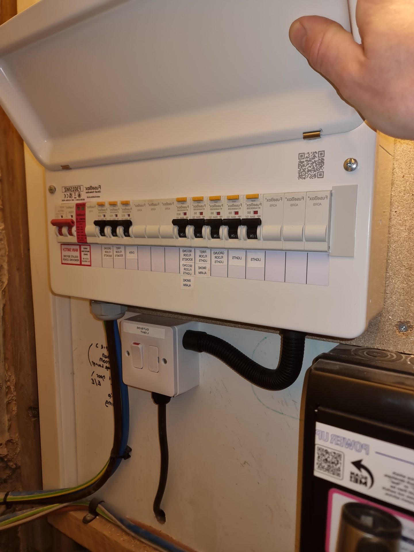 Professional electrician inspecting electrical panel